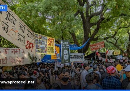 Young Indian demonstrators holding satirical signs during a 2026 protest in New Delhi
