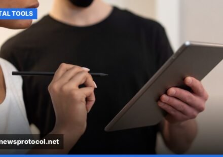 A diverse team collaborates on a digital project, using various online tools on laptops and tablets in a modern office.