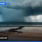 A stormy beach scene in Jacksonville, Florida, with rough waves and dark clouds overhead, reflecting the challenging weather conditions.
