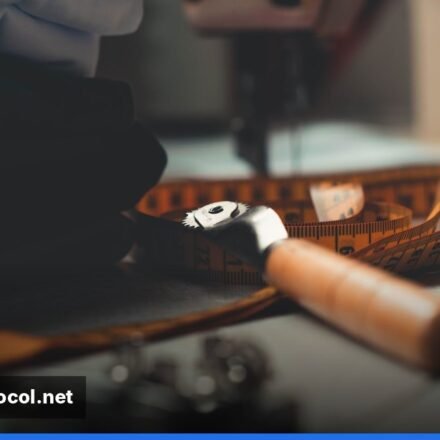 A bustling costume workshop with dressmakers cutting fabric and sewing machines in action.
