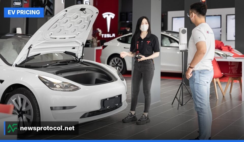 A freshly polished Tesla Model 3 displayed in a modern showroom.