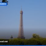 The Eiffel Tower stands tall against a clear sky in Paris, symbolizing France's iconic status.