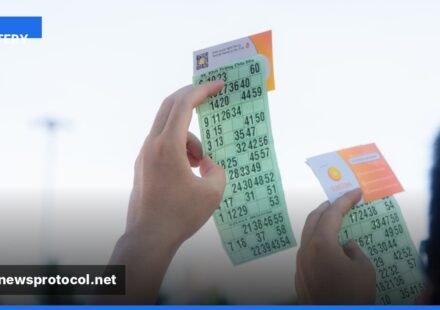 ** A close‑up of Lotto Max tickets and a glowing jackpot display at night. **