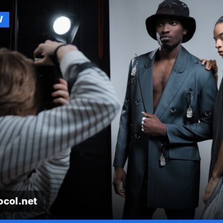 Models preparing backstage at a fashion show, adjusting outfits and makeup before walking the runway.